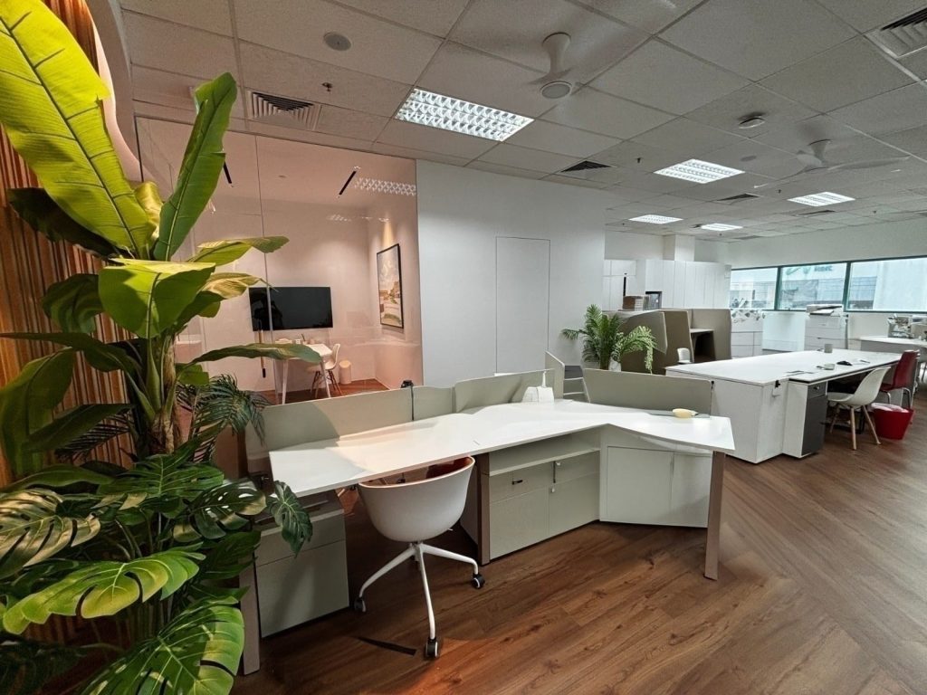 An office interior fit-out featuring plants and wooden-tone flooring
