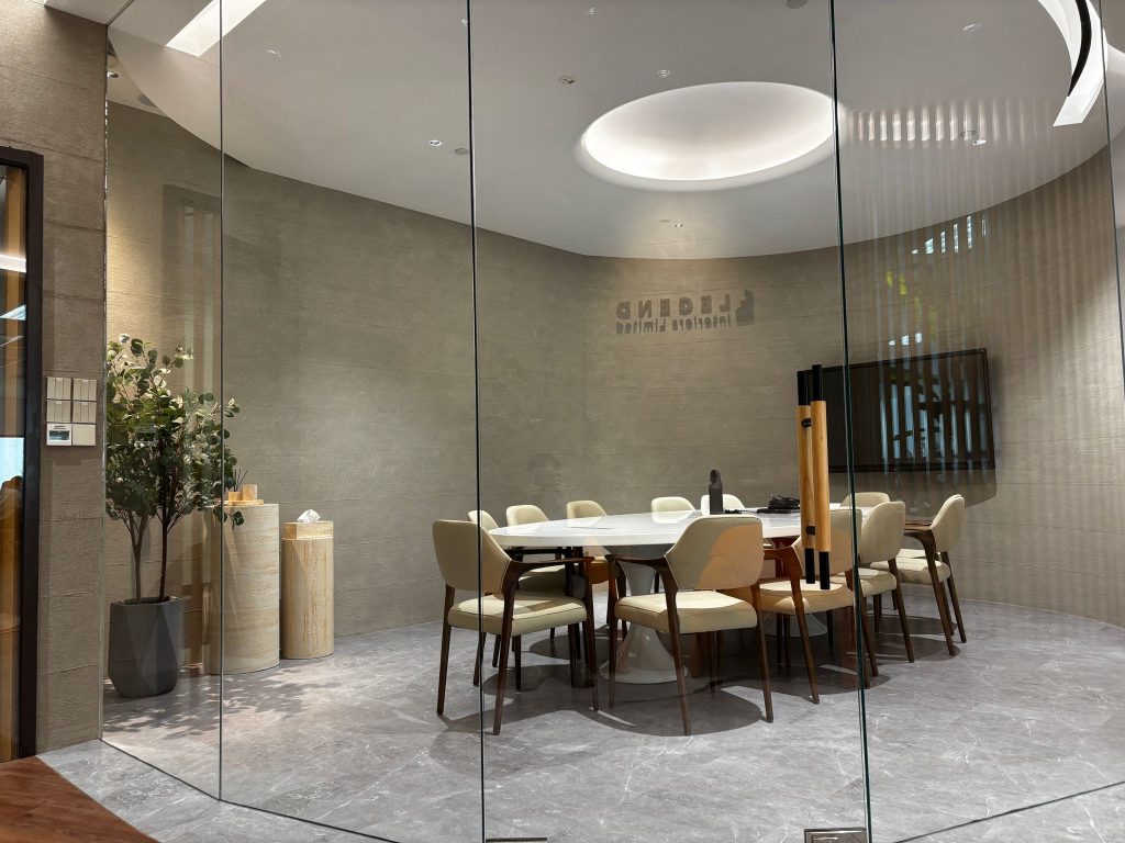An office interior fit-out featuring a glass-partitioned meeting room