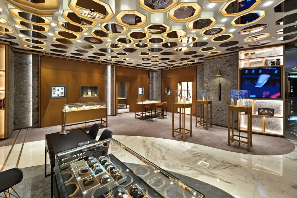 Legend Interiors-designed Four Seasons watch boutique with geometric ceiling, warm lighting, and display cases
