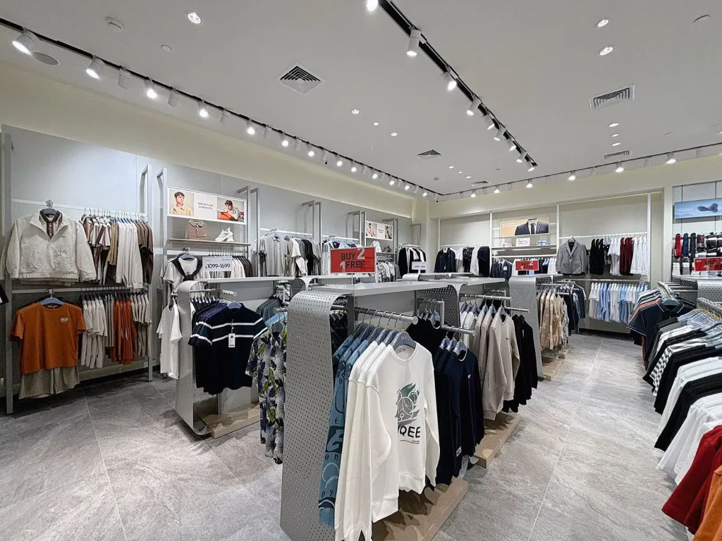 "A retail interior fit-out project by Legend Interiors: An apparel retail store with clothing tops hanging from racks.