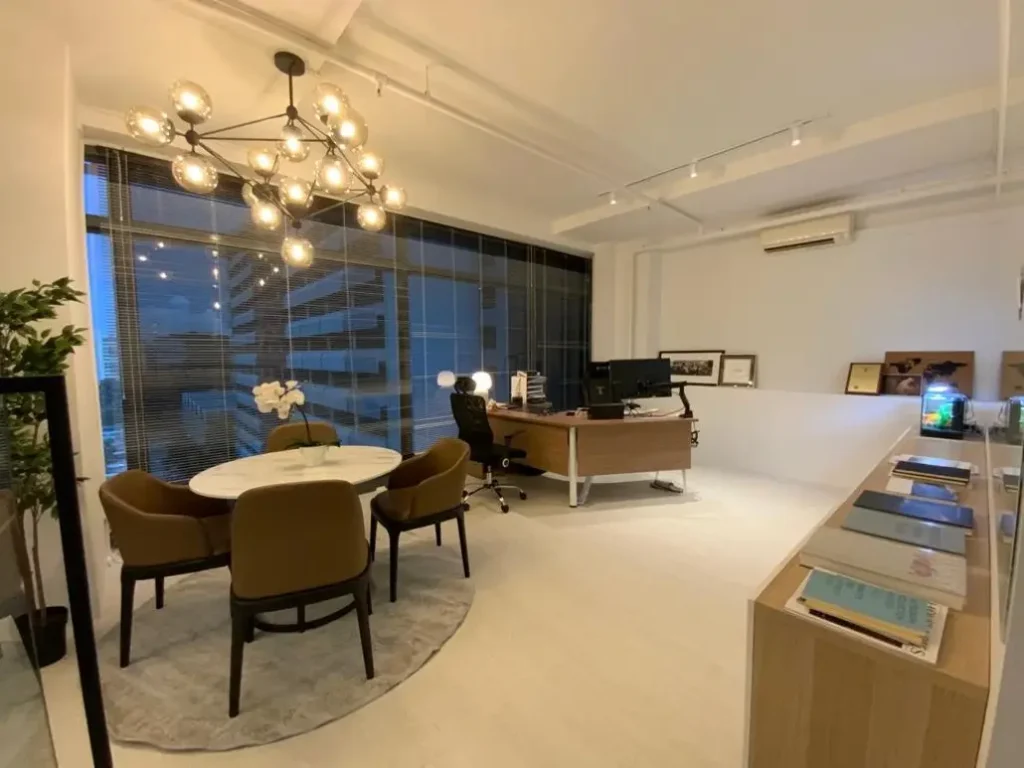 A cosy office featuring warm, overhead statement lights