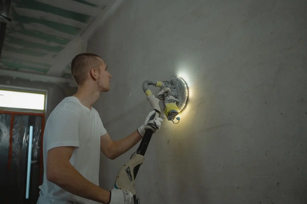Interior contractors performing wall finishing and surface preparation works